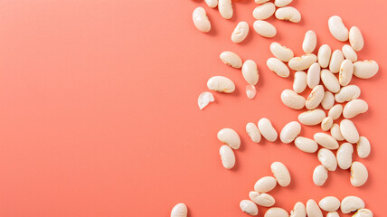 Pile of white beans on pink background