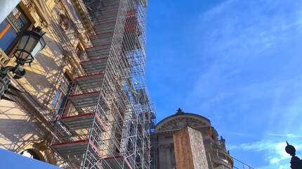 Scaffolding during renovation work of an old historical building in the center of Paris.