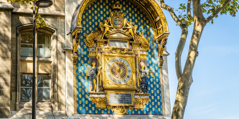 Fototapeta na wymiar Golden clock of the Tour de l'Horloge, a clock tower in Paris, France
