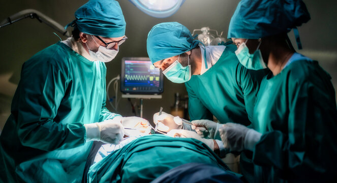 Professional Medical Doctors and team performing surgical operation in bright Modern operating room with lighting equipment in hospital.