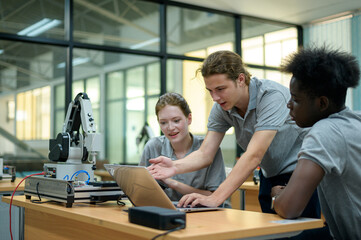 Fototapeta premium Trainee Robotics engineer learning with Programming and Manipulating Robot Hand