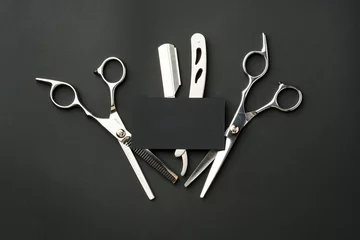 Fotobehang Hairdressing scissors and businesscard mock up on black background © fotofabrika