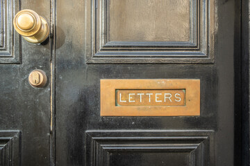 Grand front door and letterbox with word 'Letter' engraved