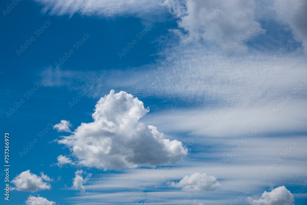 Wall mural blue sky with moving cirrus cloud bands and some cluster clouds