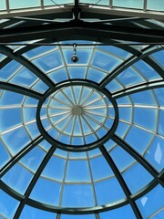 Abstract glass ceiling against a blue sky