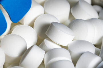Detailed close-up of white mints candy that look like medicine or pills.