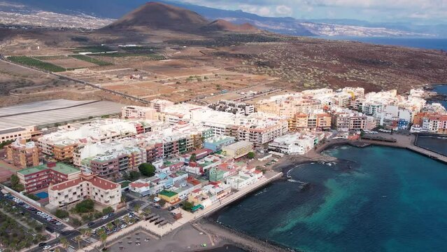Vacation footage of tourist resort with hotels, hotels and sea beach. Aerial tracking shot, relax, sunbath, tanning, travel holidays in resort. Tenerife, Canary island. Lifestyle background 4K