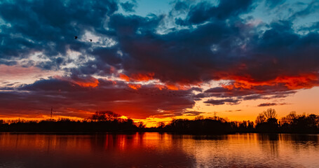 Summer sunset with reflections near Plattling, Isar, Bavaria, Germany