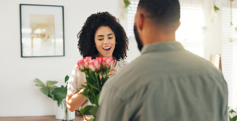 Couple, hug and flowers as surprise for valentines day with love bouquet or relationship, anniversary or behind. Man, woman and embrace in home with roses for marriage or date, celebration or present