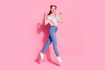 Full body size photo of redhair funky girl hipster in casual garment jump raised fists up started big sale isolated on pink color background