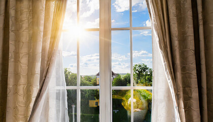 Sun shines in open window, blowing wind moves curtain.