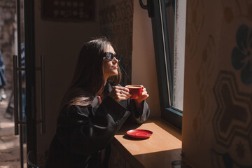 Thoughtful brunette woman drinking coffee in cafe, lifestyle, coffee, communication and local...