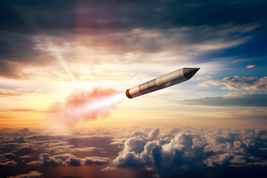 Rocket flies with a plume of smoke in the sky, launching at combat targets at sunset sky