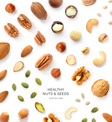 Creative layout made of pecan, almond, sunflower seeds, pumpkin seeds, walnut, cashew, pistachio hazelnut on the white background. Flat lay. Macro concept of nuts and seeds.