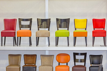 Colour Chairs in Row at Shelf