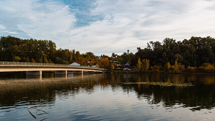 Fototapeta premium Autumn or indian summer view with reflections and a bridge near Zeholfing, Landau, Isar, Dingolfing-Landau, Bavaria, Germany