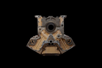 The engine of a mining dump truck in disassembled condition on a black isolated background. Huge engine of a mining dump truck.