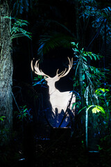 Naklejka premium Singapore - 7 March 2024: Stag Patronus at Harry Potter Forbidden forest experience at Siloso Point, Coastal Trail, Sentosa. It is outdoor trail with Lighting and Interactive Magic