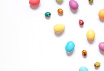 Colorful painted Easter eggs on the white background. Top view. Copy space