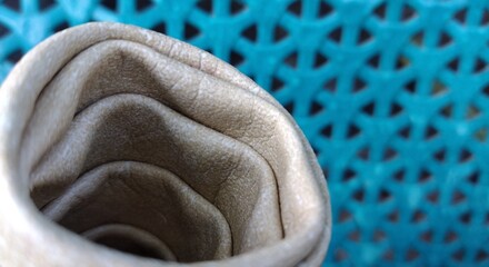 Woolen fabric on a blue background. Selective focus.