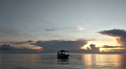 Sunset over the sea. Beautiful sunset over the sea. The sun is reflected in the water.