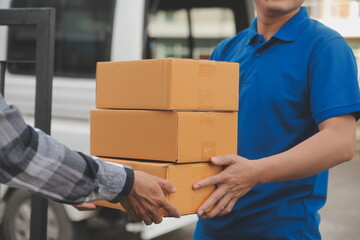 Asian delivery express courier young man use giving boxes to woman customer he wearing protective...