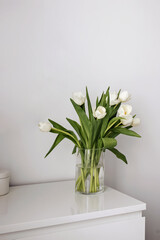 White tulips in the vase, minimalist interior