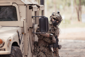 Soldiers in camouflage uniforms hold weapons ready to fire, By hiding on the side military...