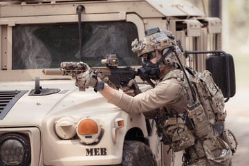 Soldiers in camouflage uniforms hold weapons ready to fire, By hiding on the side military...