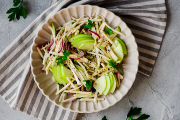 Apple celery root slaw in ceramic bowl. selective focus