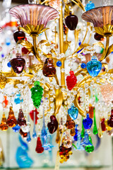 Colorful crystal or glass pendants chandelier or lamp from the world-famous Murano glass. Traditional venetian glass chandelier in branded gift shop, Murano island, Venice, Italy