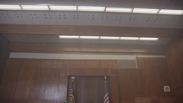 Tilt down reveal of court room empty trial