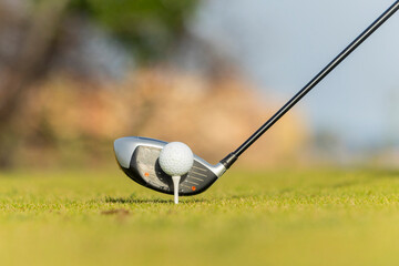 Close-up golf club and ball on tee ready for swing