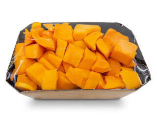 Raw pumpkin cleaned and cut into pieces in vacuum-sealed cardboard tray isolated