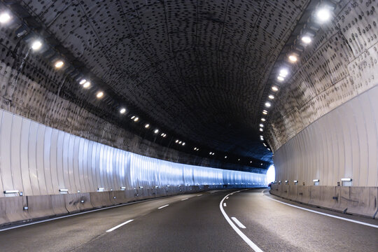 Modern illuminated tunnel with curved road