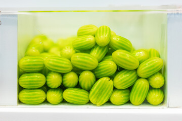 Fresh green cucamelons in glass container