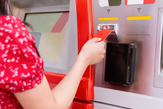 Woman using ATM for banking transaction