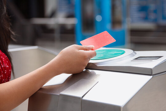Person using contactless card at subway entrance