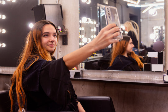 Woman capturing her new hairstyle at the salon