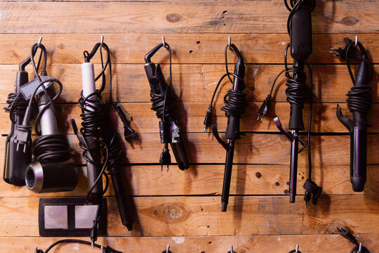 Professional hair styling tools organized on a wall