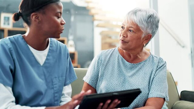 Senior care, tablet and old woman on sofa with caregiver, advice and medical consultation in home. Conversation, homecare and elderly person on couch with nurse, digital app and health insurance.