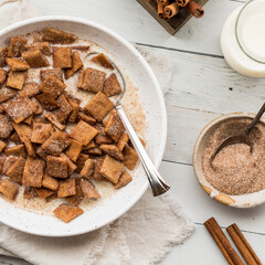 A bowl of homemade cinnamon toast crunchy cereal in milk.