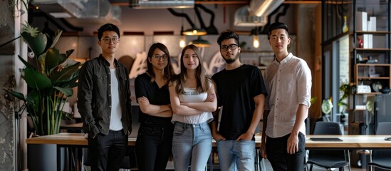 group of young entrepreneurs posing for the camera in a startup