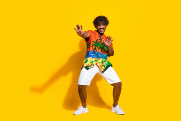 Fototapeta na wymiar Full length photo of cool cheerful guy wear hawaii print shirt dancing celebrate vacation trip isolated on yellow color background
