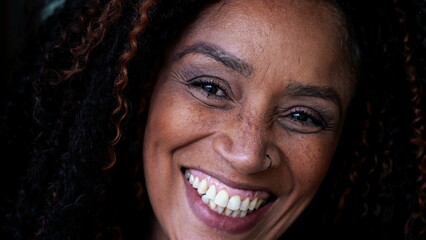One happy middle-aged black woman close-up face smiling at camera. South American female person of African descent - obrazy, fototapety, plakaty