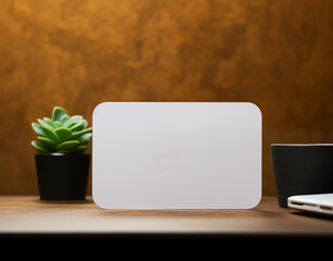 Mockup of white business paper card with rounded corners on workspace desk background