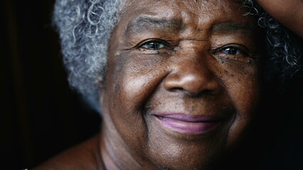 joyful South American elderly black lady in 80s depicting wisdom wrinkles in old age. Gray-hair...