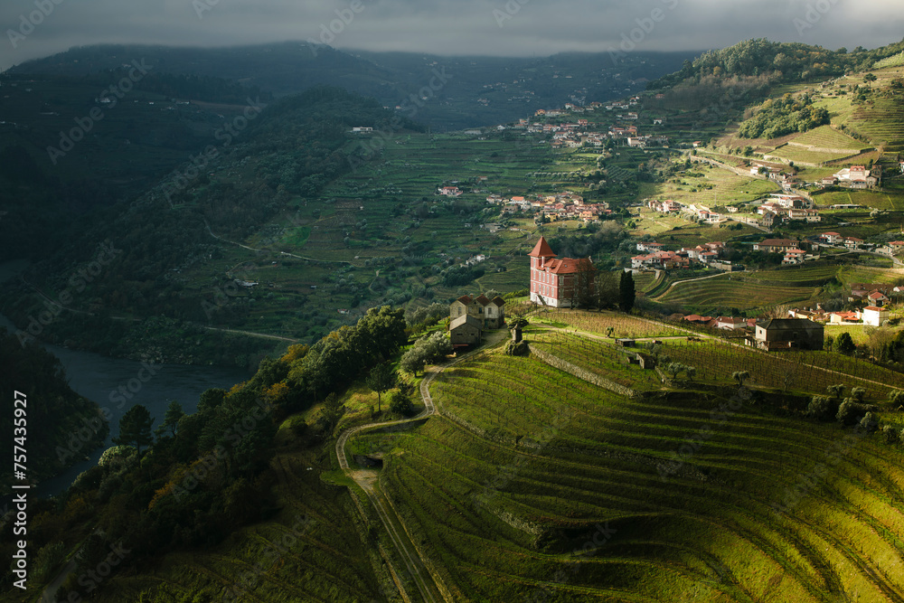 Sticker A view of a river and a village in the hills of the Douro Valley in northern Portugal.