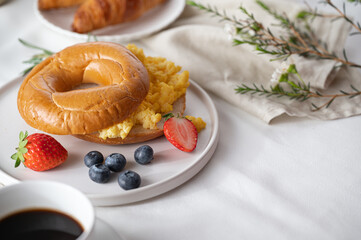 Close-up breakfast eggs berries and strawberry fruit on a white plate, Space for text