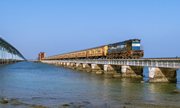 Indian Railways passenger train crossing historical , 2 kms long Pamban sea bridge.
